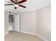 Spacious bedroom with ceiling fan and updated flooring at 3012 Parkway Blvd # 102, Kissimmee, FL 34747