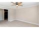 Spacious bedroom with ceiling fan and access to bathroom at 3012 Parkway Blvd # 102, Kissimmee, FL 34747