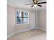 Bedroom with ceiling fan and window with blinds at 3012 Parkway Blvd # 102, Kissimmee, FL 34747