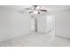 Simple bedroom with tile floors and ceiling fan, leading to bathroom at 359 Marquee Dr, Kissimmee, FL 34758