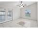 Bright dining room with tile floors, access to enclosed patio, and ceiling fan at 359 Marquee Dr, Kissimmee, FL 34758