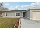 Newly constructed home with a landscaped lawn and attached garage at 359 Marquee Dr, Kissimmee, FL 34758
