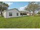 House exterior with a large backyard and trees at 359 Marquee Dr, Kissimmee, FL 34758