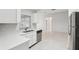 White kitchen with stainless steel appliances and view into the dining area at 359 Marquee Dr, Kissimmee, FL 34758