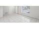 Open concept living room with tile floors and large window at 359 Marquee Dr, Kissimmee, FL 34758