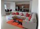 Open living room with sectional sofa and kitchen view at 5231 Maddie Dr, Haines City, FL 33844