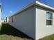 Side view of a one-story home with gray exterior and landscaping at 5231 Maddie Dr, Haines City, FL 33844