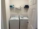 Bright laundry room, washer, dryer, and shelving at 5231 Maddie Dr, Haines City, FL 33844