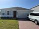 One story home with a two-car garage and a well-maintained lawn at 5231 Maddie Dr, Haines City, FL 33844