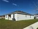 Rear view of a one-story home with a covered patio and AC unit at 5231 Maddie Dr, Haines City, FL 33844