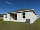 Rear view of a one story home with a covered patio and AC unit at 5231 Maddie Dr, Haines City, FL 33844