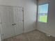 Spacious bedroom with double doors and window at 5231 Maddie Dr, Haines City, FL 33844