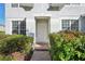 White front door entrance with brick walkway and lush green bushes at 545 Palio Ct, Ocoee, FL 34761