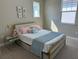 Cozy bedroom with a full-size bed, light blue blanket, and gold frame at 14739 Glade Hill Park Way, Winter Garden, FL 34787