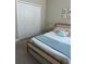 Well-lit bedroom with full bed, neutral color palette, and ample closet space at 14739 Glade Hill Park Way, Winter Garden, FL 34787