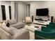 Spacious living room featuring a sectional sofa, large TV, and stylish accent chairs at 14739 Glade Hill Park Way, Winter Garden, FL 34787