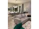 Open living room with gray sectional sofa, geometric rug, and large windows at 14739 Glade Hill Park Way, Winter Garden, FL 34787