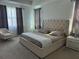 Large main bedroom with king-size bed and plush headboard, featuring ample natural light at 14739 Glade Hill Park Way, Winter Garden, FL 34787
