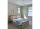 Charming bedroom featuring a full-size bed, soft color scheme and natural light at 14739 Glade Hill Park Way, Winter Garden, FL 34787