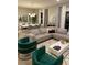 Open concept living and dining area with gray sectional sofa and green accent chairs at 14739 Glade Hill Park Way, Winter Garden, FL 34787