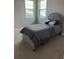 Bright bedroom with a twin bed and large windows at 14739 Glade Hill Park Way, Winter Garden, FL 34787