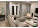 Bright living room with sectional sofa, large windows, and elegant gray curtains at 14739 Glade Hill Park Way, Winter Garden, FL 34787