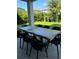 Outdoor patio with a large wood table and black chairs at 14739 Glade Hill Park Way, Winter Garden, FL 34787