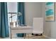 Modern home office with white desk and teal curtains at 1683 Three Bars Rd, Kissimmee, FL 34744