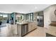 Open kitchen boasts an island, stainless steel appliances, and granite countertops at 1683 Three Bars Rd, Kissimmee, FL 34744