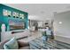Open concept living room with teal accent wall and view to kitchen at 1683 Three Bars Rd, Kissimmee, FL 34744
