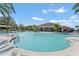 Large community pool with palm trees and lounge chairs at 1683 Three Bars Rd, Kissimmee, FL 34744