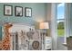 Bedroom featuring a crib, changing table, and animal-themed decor at 1683 Three Bars Rd, Kissimmee, FL 34744