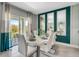 Modern dining area with white table and chairs and view to backyard at 1683 Three Bars Rd, Kissimmee, FL 34744