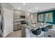 Modern kitchen with stainless steel appliances and an island with seating at 1683 Three Bars Rd, Kissimmee, FL 34744