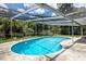 Kidney shaped pool with screened enclosure at 2518 Sweetwater Trl, Winter Park, FL 32789