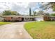 Brick ranch home with a two-car garage and a curved driveway at 2518 Sweetwater Trl, Winter Park, FL 32789