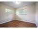 Bright bedroom with hardwood floors and two windows at 2518 Sweetwater Trl, Winter Park, FL 32789