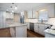 Updated kitchen with white cabinets, granite island, and stainless steel appliances at 2518 Sweetwater Trl, Winter Park, FL 32789