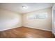 Bright bedroom featuring hardwood floors and large window at 2518 Sweetwater Trl, Winter Park, FL 32789