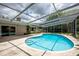 Kidney shaped pool with screened enclosure at 2518 Sweetwater Trl, Winter Park, FL 32789