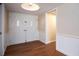 Bright entryway with double doors, hardwood floors, and wainscoting at 2518 Sweetwater Trl, Winter Park, FL 32789