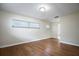 Bright bedroom with hardwood floors and large window at 2518 Sweetwater Trl, Winter Park, FL 32789