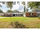 Brick ranch house with a two-car garage and lush green lawn at 2518 Sweetwater Trl, Winter Park, FL 32789