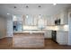 Updated kitchen with white cabinets, granite countertops, and wood island at 2518 Sweetwater Trl, Winter Park, FL 32789