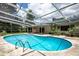 Kidney shaped pool with screened enclosure at 2518 Sweetwater Trl, Winter Park, FL 32789