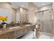 Double vanity bathroom with granite countertop and glass shower at 3215 Brasilia Ave, Kissimmee, FL 34747
