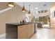 Modern kitchen with island, stainless steel appliances, and view to living room at 3215 Brasilia Ave, Kissimmee, FL 34747