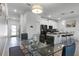 Open concept dining room with glass table and kitchen views at 4285 Quote St, Kissimmee, FL 34746