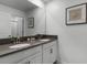 Bathroom with double vanity, dark countertop, and large mirror at 4285 Quote St, Kissimmee, FL 34746
