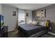 Primary bedroom with gray upholstered bed, yellow pillows, and large window at 4285 Quote St, Kissimmee, FL 34746